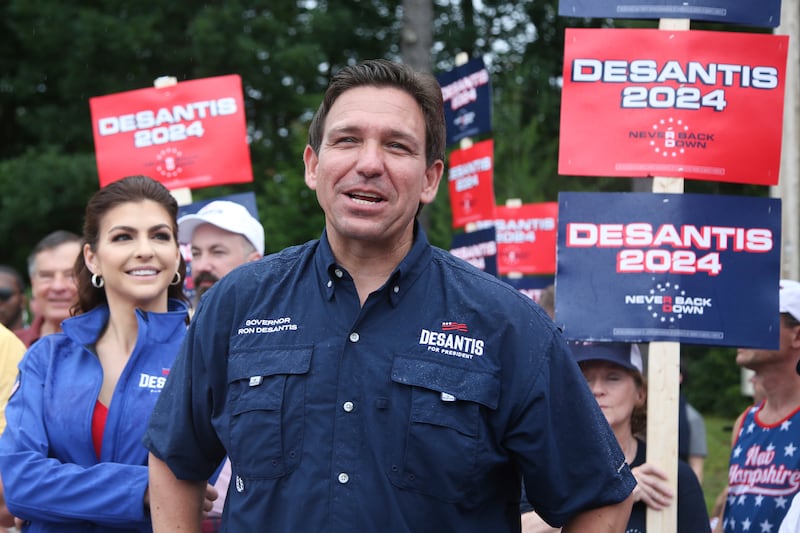 Republican presidential candidate and Florida Gov. Ron DeSantis and his wife Casey walk in the Fourth of July parade.