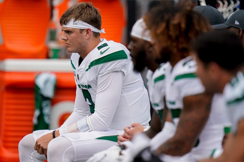 New York Jets quarterback Zach Wilson sits on the bench during a game against the Tennessee Titans on Oct. 3, 2021.