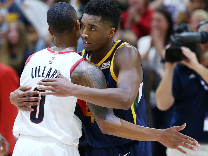 Utah Jazz guard Donovan Mitchell (45) and Portland Trail Blazers guard Damian Lillard (0) hug after the game as the Utah Jazz and the Portland Trailblazers play at Vivint Arena in Salt Lake City on Wednesday, Nov. 1, 2017. Utah won 112-103 in Overtime.