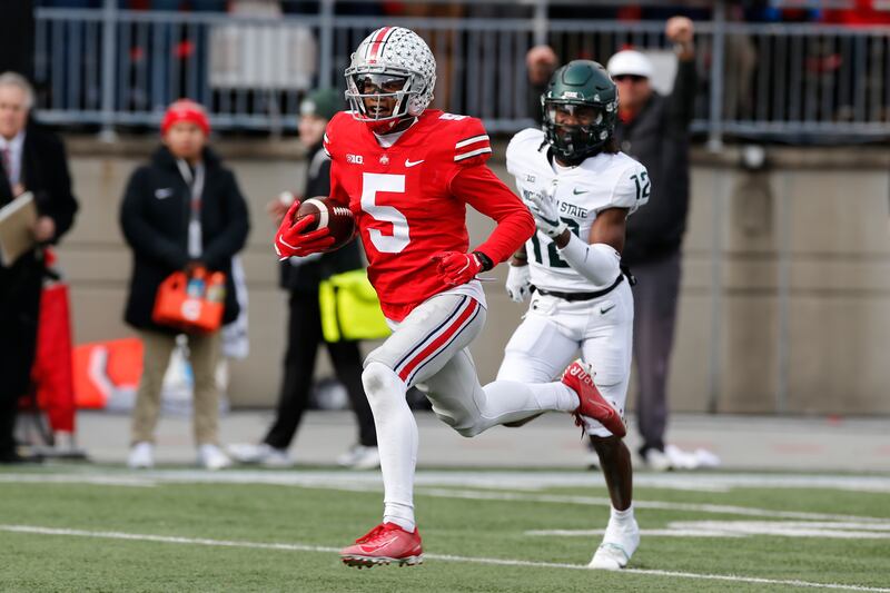 Ohio State receiver Garrett Wilson runs after a catch