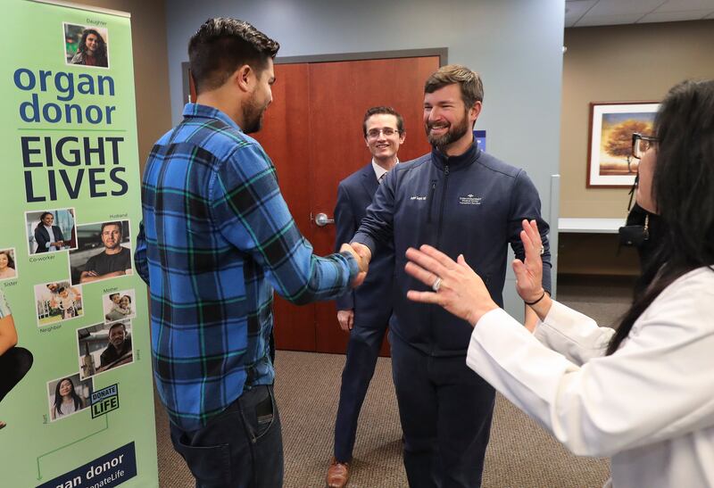 Jeff Willis, left, the 3,000th kidney transplant recipient at Intermountain Medical Center, shakes hands with his surgeon, Dr. Andrew Gagnon.