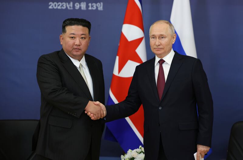Russian President Vladimir Putin, right, and North Korea’s leader Kim Jong Un shake hands during their meeting.