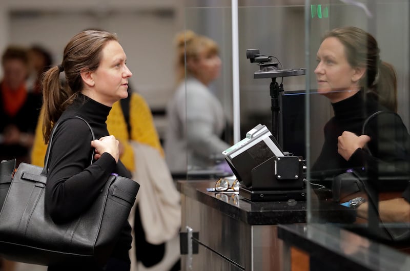 Katrina Poulsen, a visitor from Denmark, stands in front of a face recognition camera after arriving at customs at Orlando International Airport, Thursday, June 21, 2018, in Orlando, Fla. Florida's busiest airport is becoming the first in the nation to re