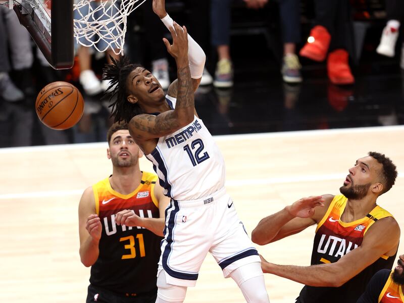 Memphis Grizzlies guard Ja Morant gets a reverse dunk in a playoff game against the Utah Jazz.