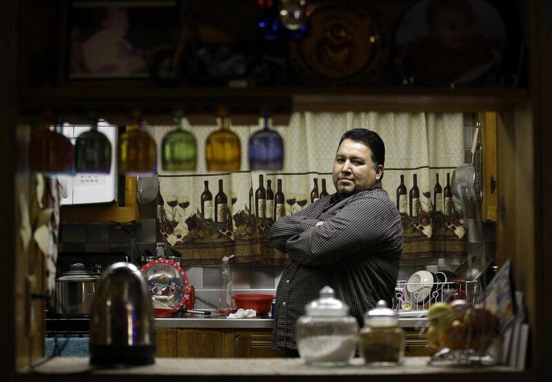 In this Dec. 19, 2014 photo, Felipe Diasdado poses at his home in Chicago. He came to the U.S. illegally in 1997.