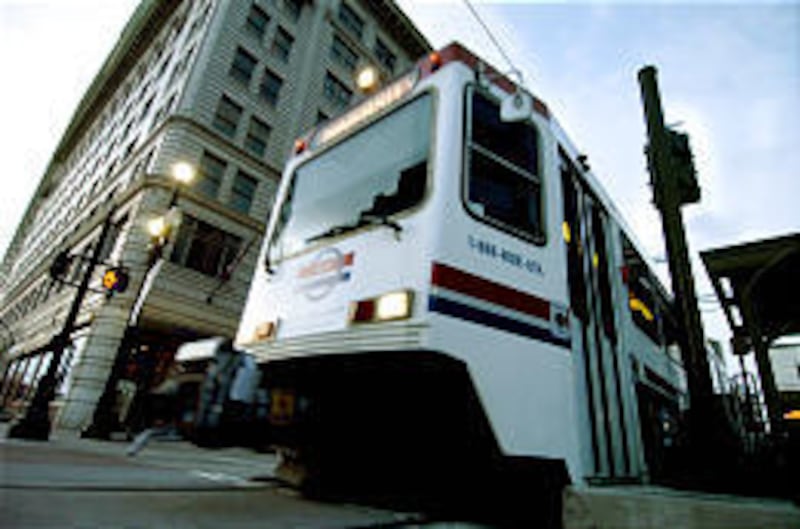 A TRAX train leaves the Gallivan Plaza station on Main Street en route to Rice-Eccles Stadium before the Utah-BYU football game.