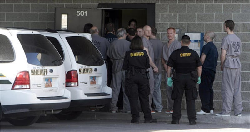 Prisoners are escorted into the newly reopened Oxbow Jail in South Salt Lake on Saturday. Focus is on rehabilitation.