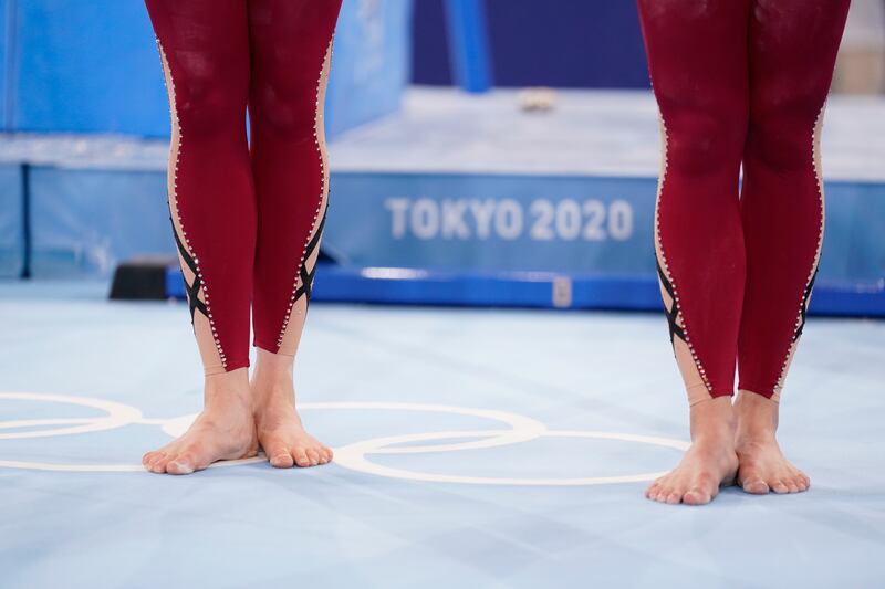 German gymnasts stand with their unitard costumes at the 2020 Summer Olympics, Sunday, July 25, 2021, in Tokyo.