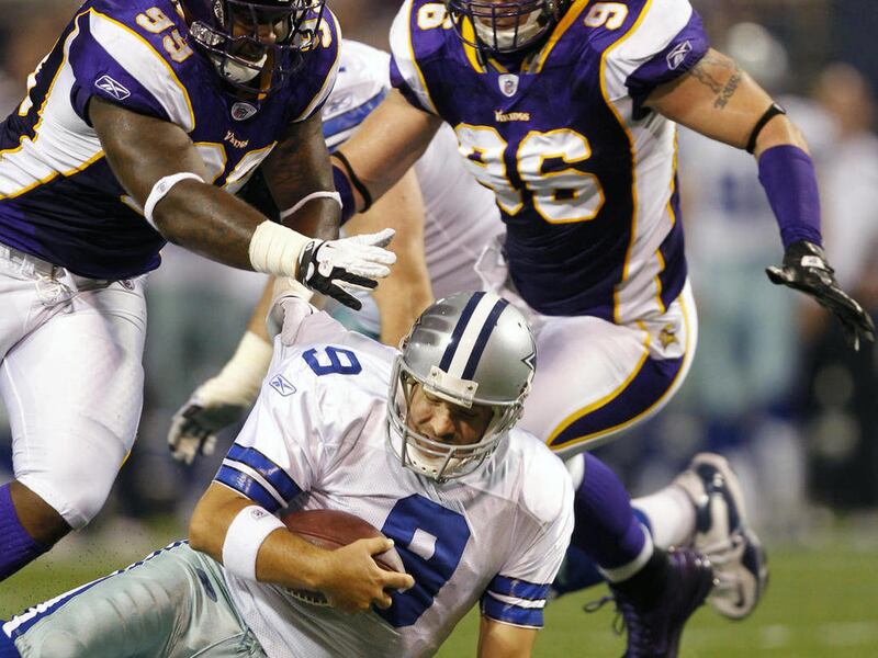 Dallas Cowboys quarterback Tony Romo is sacked by Minnesota Vikings defensive tackle Christian Ballard, left, and defensive end Brian Robison (96) during the first half of an NFL preseason football game, Saturday, Aug. 27, 2011, in Minneapolis.
