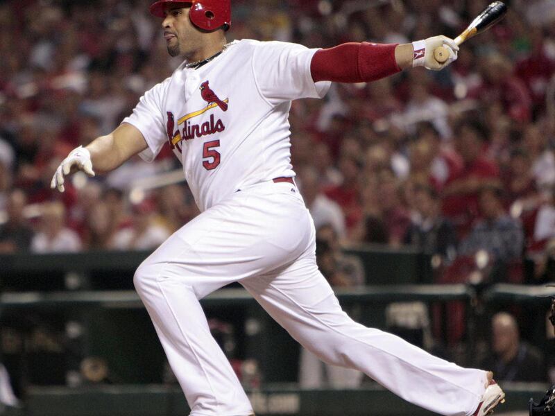 FILE - This Sept. 17, 2010, file photo shows St. Louis Cardinals' Albert Pujols hitting an RBI-double during the first inning of a baseball game against the San Diego Padres, in St. Louis. Pujols is seeking a deal that would make him one of baseball's hig