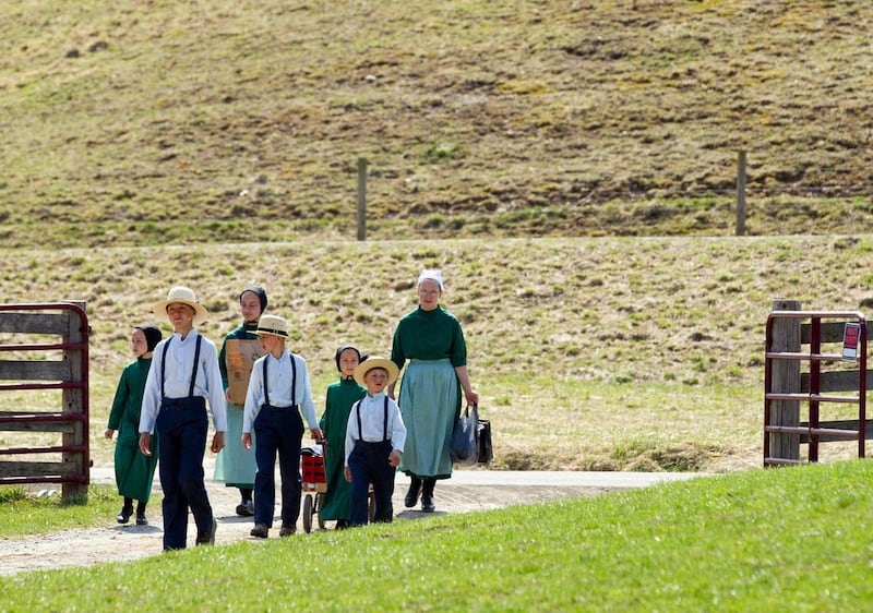 An Amish family walks to the schoolhouse for the final day of class and a picnic in Bergholz, Ohio, on April 9, 2013.