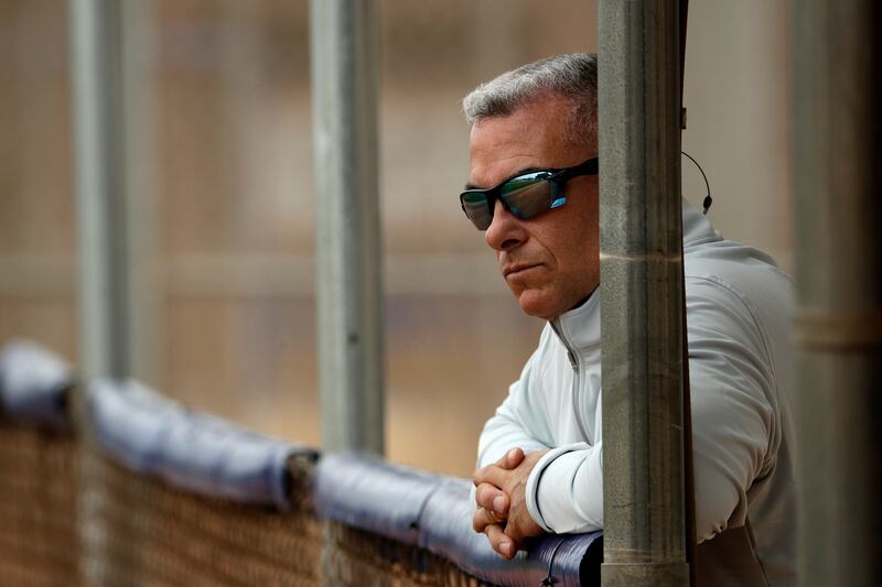 Kansas City Royals general manager Dayton Moore watches a workout during spring training baseball practice Wednesday, Feb. 13, 2019, in Surprise, Ariz. (AP Photo/Charlie Riedel)
