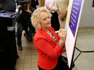 Salt Lake City Mayor Jackie Biskuspki signs a new agreement between the city, police and the Salt Lake City School District that aims to improve the role of school resource officers on campuses during a press conference at West High School in Salt Lake Ci
