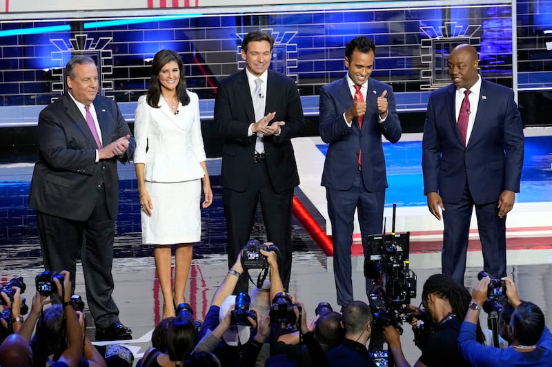 Five Republican presidential candidates stand on the debate stage.