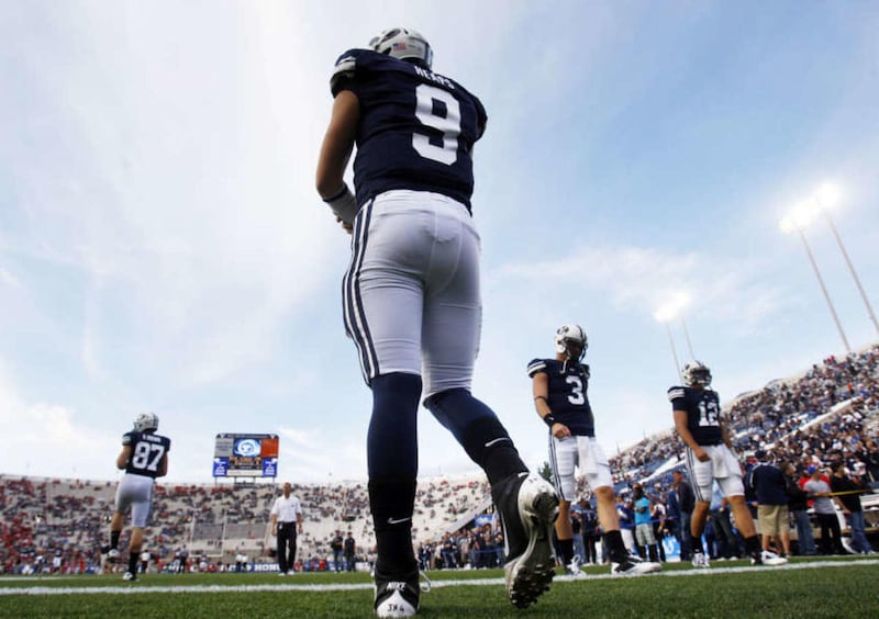 Brigham Young Cougars quarterback Jake Heaps (9) and others on the offense get warmed up prior to the game as they prepare to play Utah Saturday, Sept. 17, 2011 at Lavell Edwards Stadium.