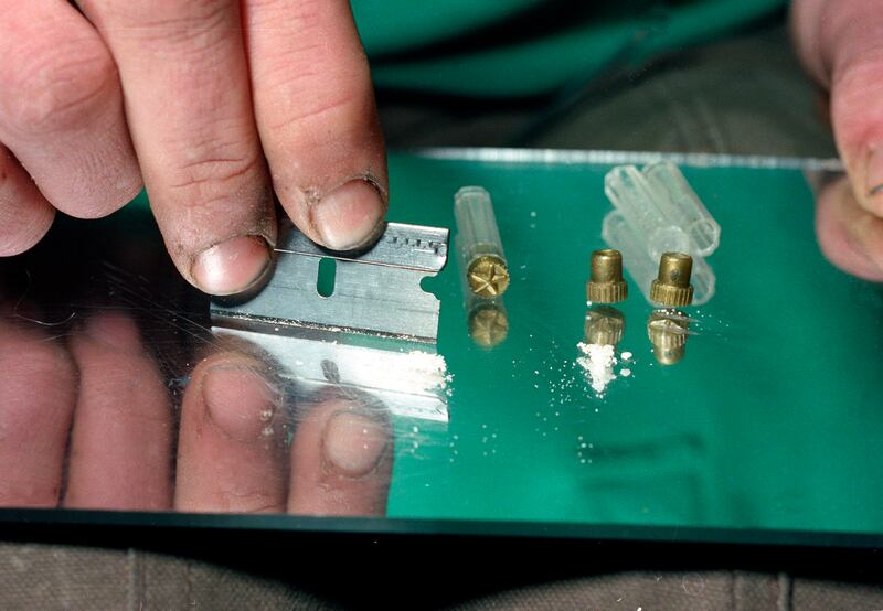 FILE - In this 1989 file photo, a razor blade is used to divide the contents of a five-dollar vile of crack, a smokable, purified form of cocaine, at a crack house in the South Bronx section of New York. Cocaine deaths have been rising, health officials s