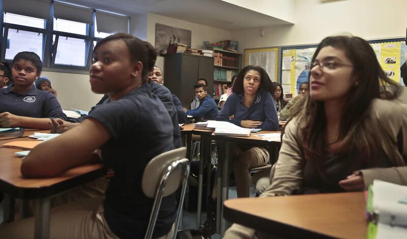 A Global Studies class of 10th and 11th graders at Bedford Academy High School listen during class on Tuesday, Dec. 3, 2013 in New York. New York Mayor Michael Bloomberg and Schools Chancellor Dennis Walcott held a press conference at the school to announ