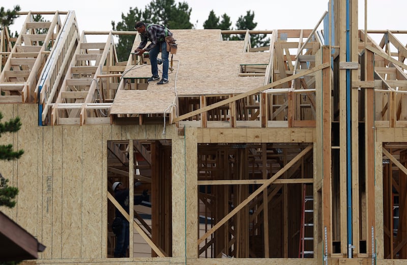 Workers toil on a multifamily dwelling in Winter Park, Colo., on Tuesday, Aug. 4, 2020.