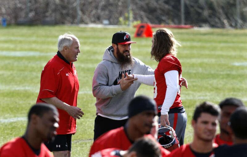 San Diego Chargers safety Eric Weddle, former player for The University of Utah, talks with defensive coordinator John Pease and meets players as the U football team practices at Spence Eccles Field House in Salt lake City Thursday, April 2, 2015.