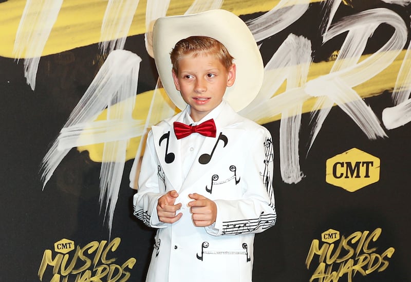FILE - In this June 6, 2018, file photo, Mason Ramsey arrives at the CMT Music Awards at the Bridgestone Arena in Nashville, Tenn. Ramsey, a preteen Illinois boy who went viral online in a video of him singing and yodeling in a Walmart store is releasing