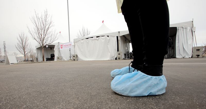 Madeline Cook, a medical assistant wears protective clothing at an appointment-only drive-thru COVID-19 testing facility set up outside University of Utah Health’s South Jordan Health Center on Friday, March 13, 2020. The testing facility will be open to the public Monday.