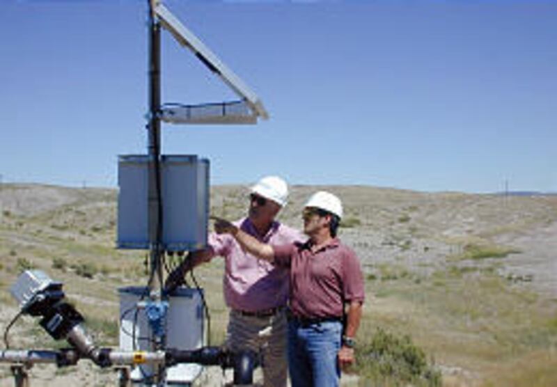 Anadarko's Rick Robitaille and Danny Morse examine a new oil well at the Salt Creek field in Wyoming.