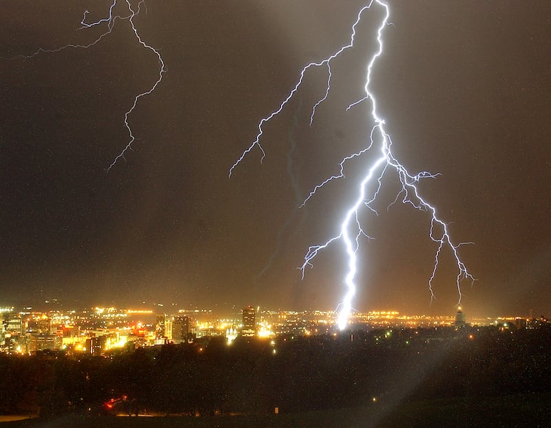 FILE - A huge lightning storm moves across the Salt Lake Valley late Aug. 3, 2004, as a bolt hits the ground in the city.