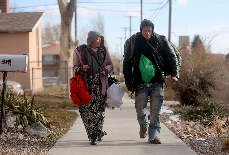 Lacey Kapsimalis and Stoner Sturgis, who have been homeless for five and nine years, respectively, walk through Salt Lake City.