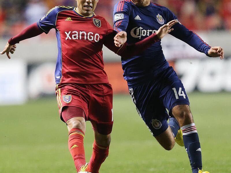 Real's Javier Morales pushes the ball ahead of Bryan de la Fuente as Real Salt Lake and Chivas USA play Oct. 23, 2013, at Rio Tinto Stadium in Sandy.