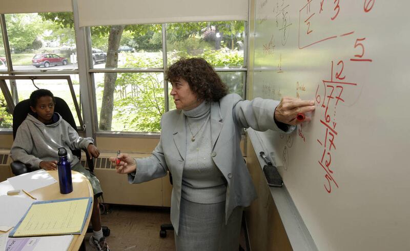 Sally Jo Gilbert de Vargas, right, sixth-grade house administrator at Whitman Middle School in Seattle, tutors summer school students including Brook Engida, 13, left, in math, Thursday, June 28, 2012.
U.S. students improved slightly in reading and mathem