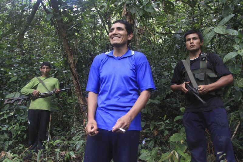 In this photo taken Tuesday, April 17, 2012, Martin Quispe Palomino, also known as "Comrade Gabriel," center, a member of the Shining Path rebel force, talks with a group of journalist in Alto Laguna, Peru. Comrade Gabriel is the youngest of the three Qu