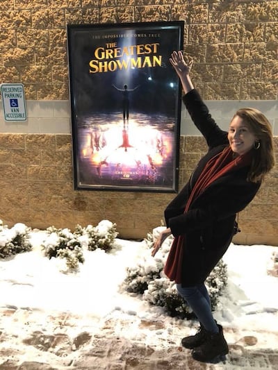 Utah singer Loren Allred poses next to a poster for the film "The Greatest Showman."