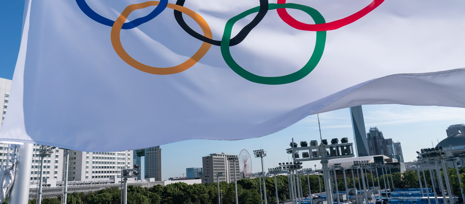 An Olympic flag flies over the the Ariake Tennis Center ahead of the 2020 Summer Olympics.