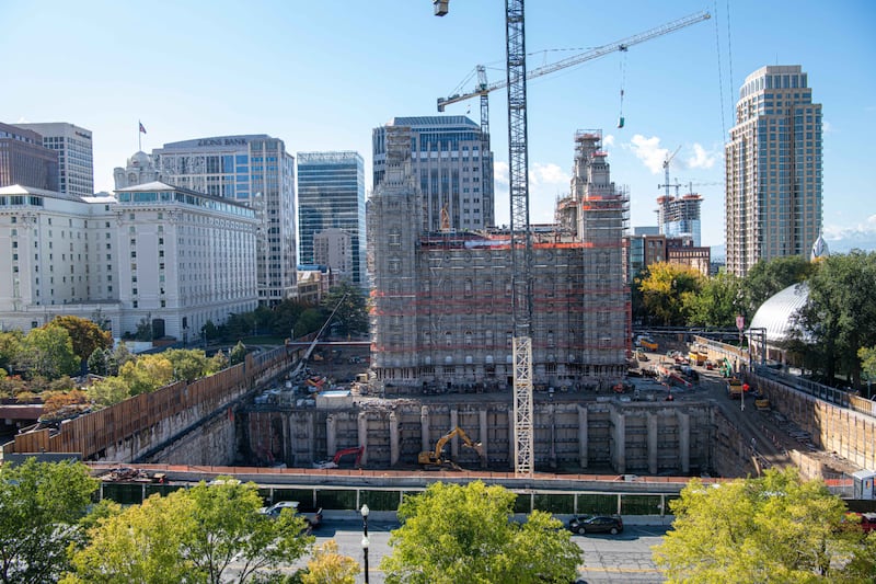 The north side of the Salt Lake Temple, with the Joseph Smith Memorial Building to the left, covered by scaffolding.