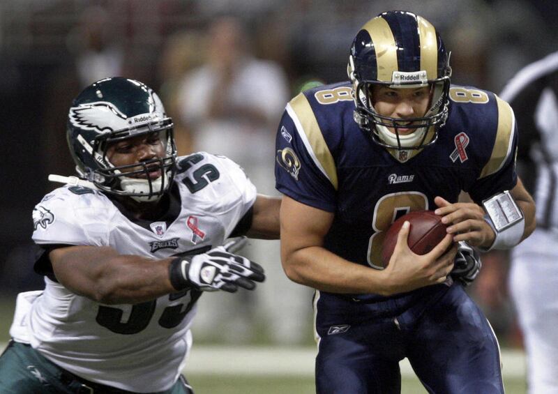 St. Louis Rams quarterback Sam Bradford, right, is sacked for a four-yard loss by Philadelphia Eagles defensive end Darryl Tapp during the third quarter of an NFL football game on Sunday, Sept. 11, 2011, in St. Louis.