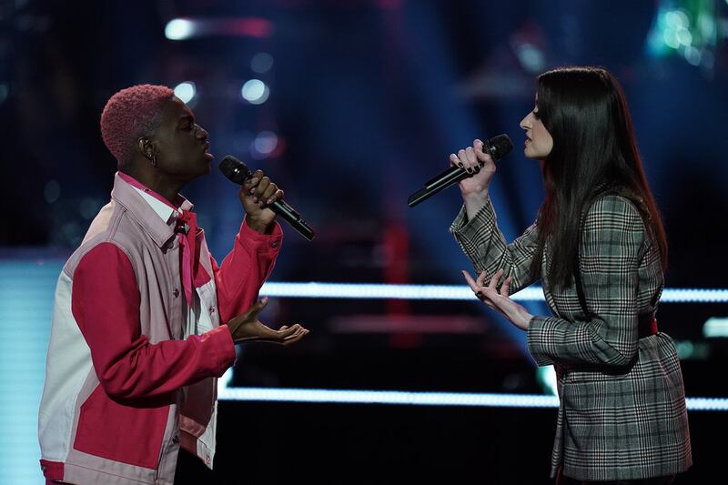 Eric Who, left, and Sydney Kronmiller compete during the Battle round on “The Voice.”