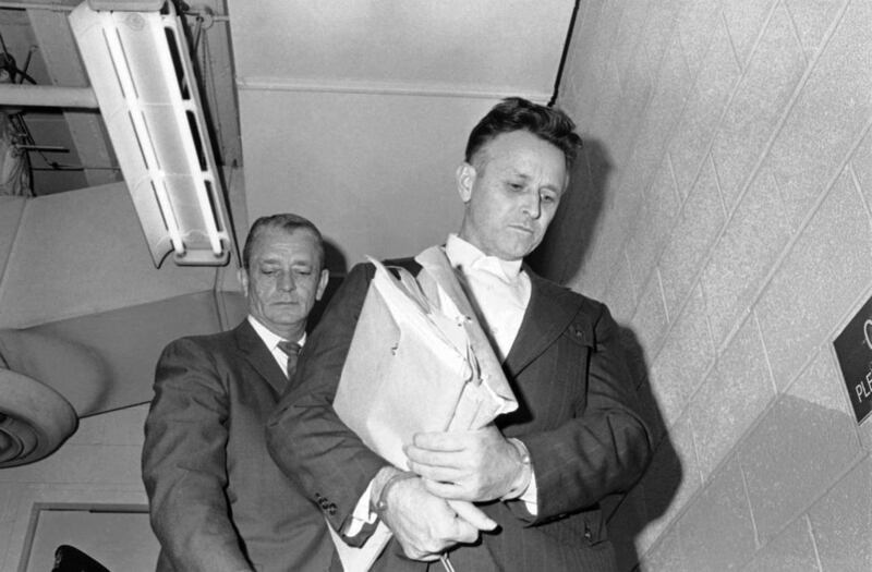 FILE - In this Oct. 22, 1974 file photo, James Earl Ray, who was sentenced to life in the slaying of Dr. Martin Luther King, leaves the federal court in Memphis, Tenn. The court is hearing evidence in Ray"™s claim that he was pressured into pleading guilt
