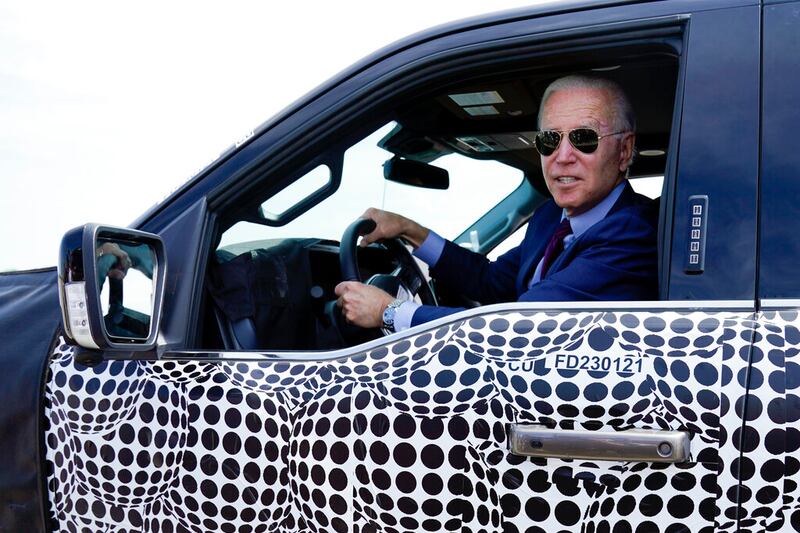 President Joe Biden drives a Ford F-150 Lightning truck.