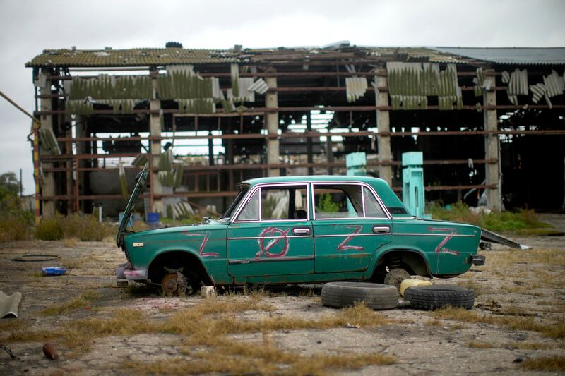 An abandoned car lies on the ground in a heavily damaged grain factory in Lyman, Ukraine.