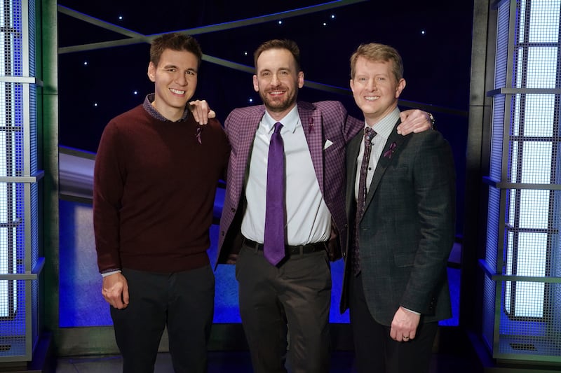 In this image released by ABC, contestants, from left, James Holzhauer, Brad Rutter and Ken Jennings appear on the set of “Jeopardy!” in Los Angeles. The all-time top money winners; Rutter, Jennings and Holzhauer, competed in a rare prime-time edition of the TV quiz show “Jeopardy! The Greatest of All Time.” Now, that tournament is re-airing May 4-15.