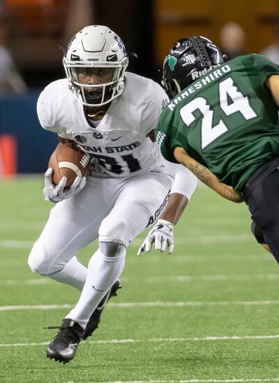 Utah State wide receiver Savon Scarver (81) attempts to get past Hawaii defensive back Kai Kaneshiro (24) in the first half of an NCAA college football game, Saturday, Nov. 3, 2018, in Honolulu.