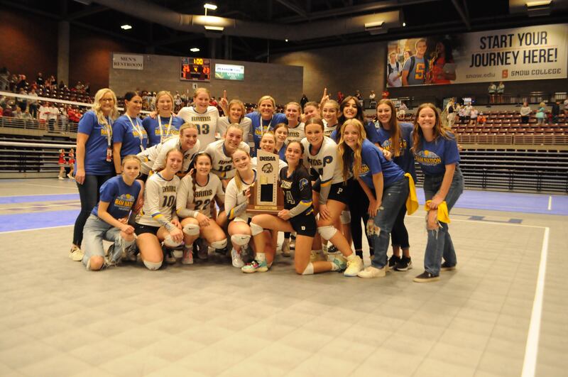 Parowan, wearing white, celebrates their 2A volleyball state championship.