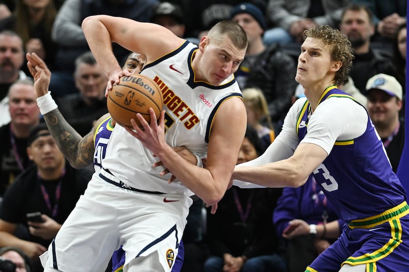 Denver Nuggets center Nikola Jokic spins on Utah Jazz forward Lauri Markkanen in Salt Lake City, Jan. 10, 2024.