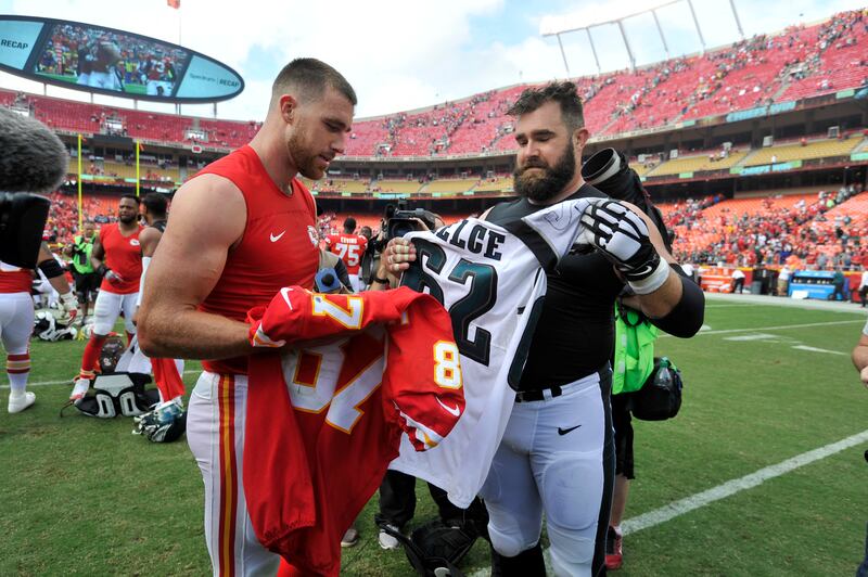 Kansas City Chiefs tight end Travis Kelce, left, and and his brother, Philadelphia Eagles center Jason Kelce (62) exchange jerseys following a game on Sept. 17, 2017.