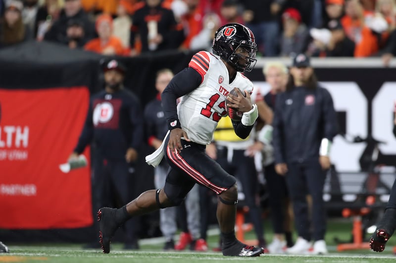 Utah quarterback Nate Johnson carries the ball against Oregon State.