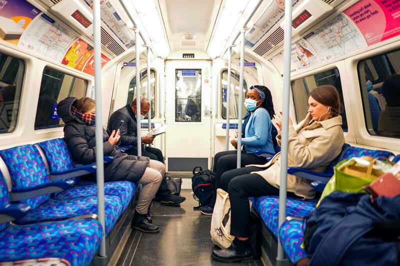 People sit on a London Underground train.