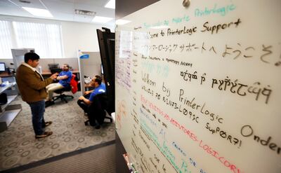 Julio Garfias, left, Mitchell Schwartz and Sal Gamez hold a discussion at PrinterLogic in St. George on Wednesday, Jan. 17, 2018.