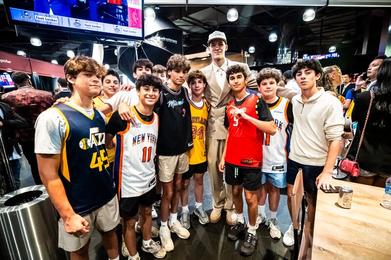 Egor Demin poses with young fans at the NBA draft Wednesday, June 25, 2025, in Brooklyn, New York.