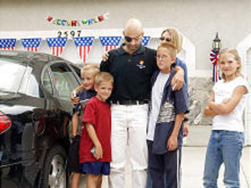 Special Forces Sgt. Layne Morris is joined by members of his family in South Jordan in August 2002. Morris was wounded in July 2002 in Afghanistan during a firefight against al-Qaida and lost the use of his right eye.