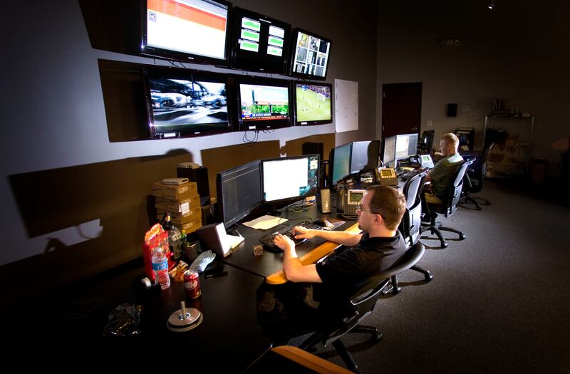 FILE - Technicians Chris Adams, left, and Josh Kester work Wednesday, Aug. 1, 2012 in the Network Operations Center of Utopia. Murray-based internet service provider Sumo Fiber was the target of a denial-of-service attack over the weekend that caused slow